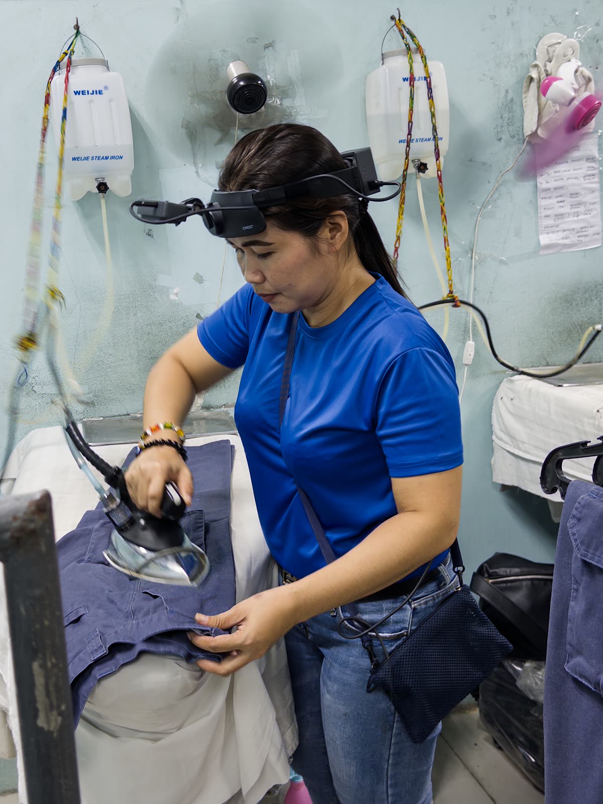 A Luckey collector wearing a head-mounted camera while ironing garments