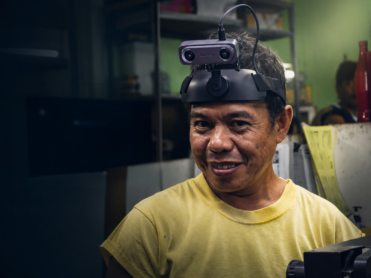 A worker wearing Luckey head-mounted stereo cameras during real-world data collection